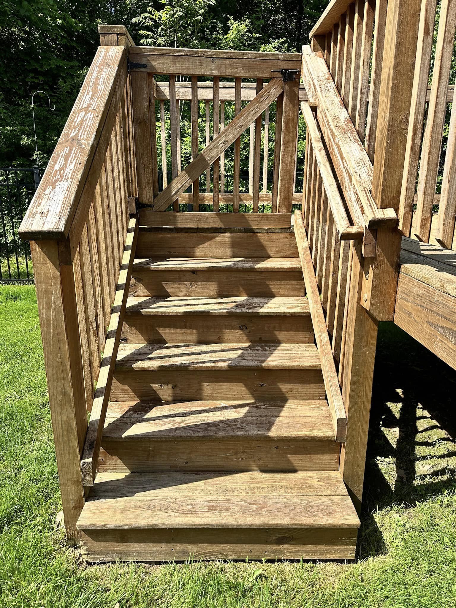 Weathered wooden deck stairs with peeling finish